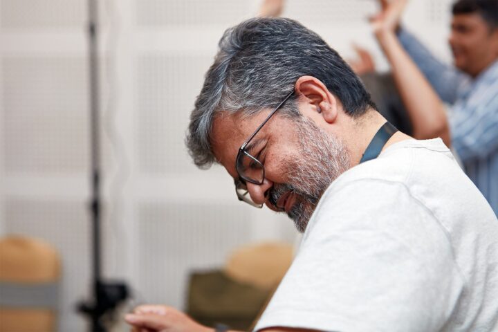 A participant with head bowed, eyes closed, during a reflective exercise