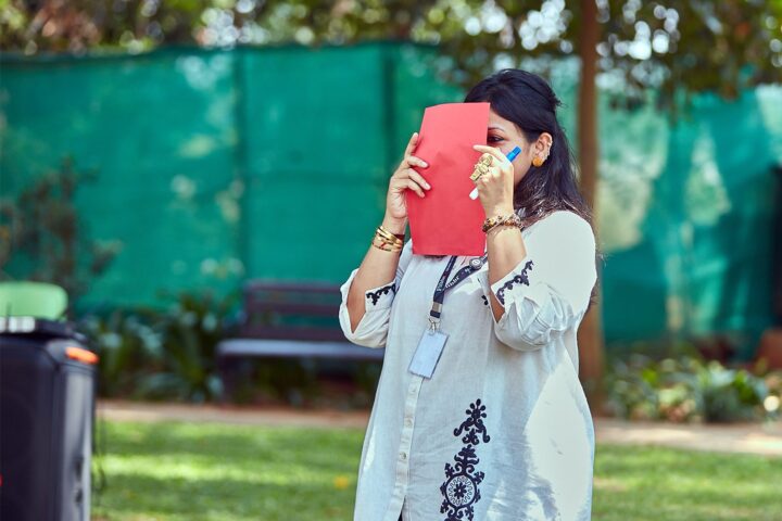 A participant during an outdoor exercise, holding a card to her face