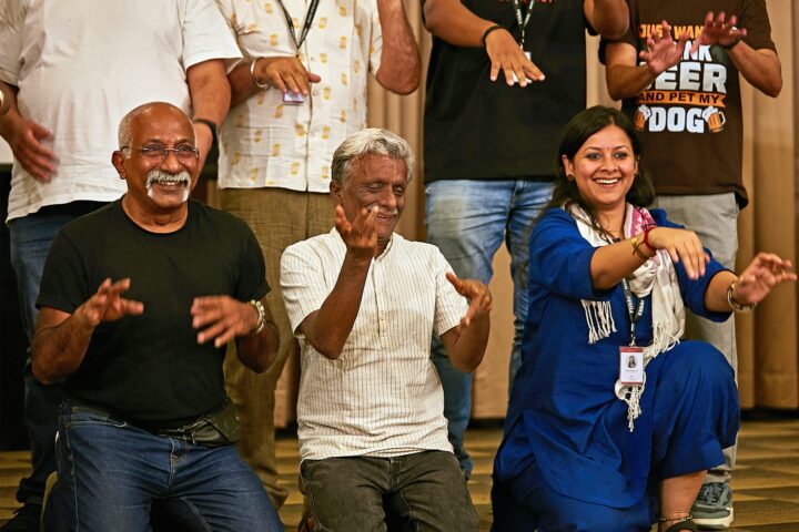Three participants clapping and laughing