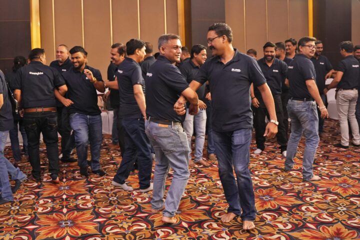 Participants working in pairs across the floor of the hall