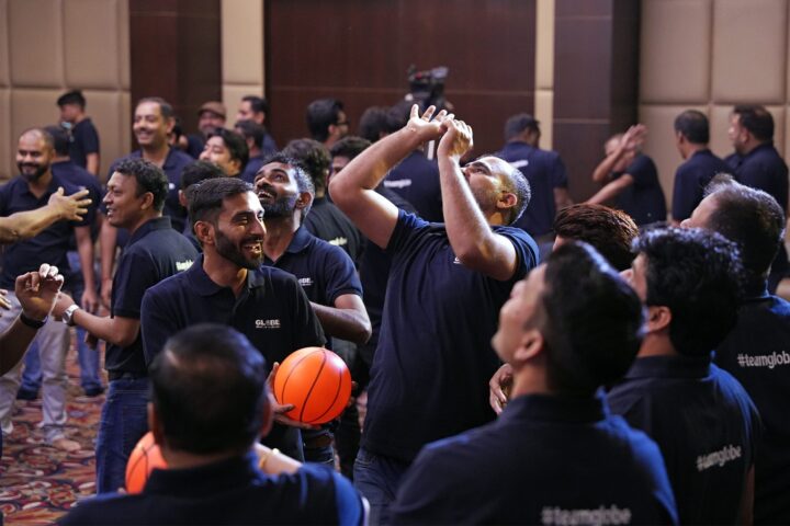 Participants reaching for an orange ball passed over the group