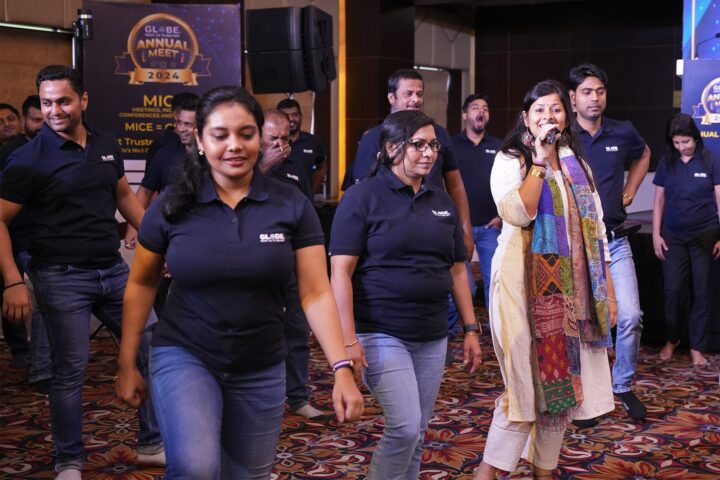 A facilitator with a microphone walking among the participants