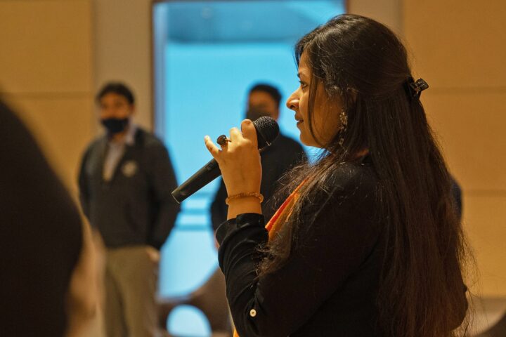A participant speaking into a microphone