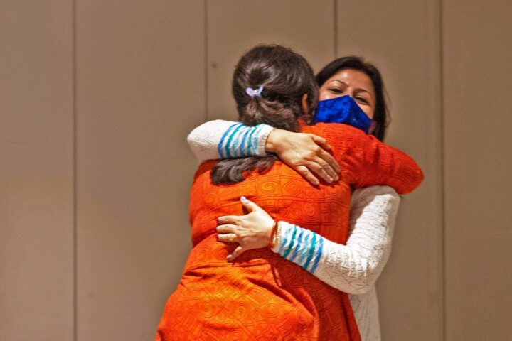 Two participants embracing