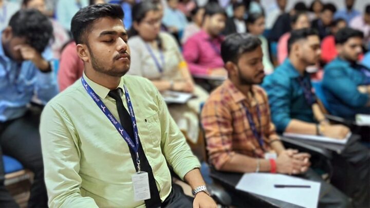 Rows of students sitting still at their desks with their eyes closed